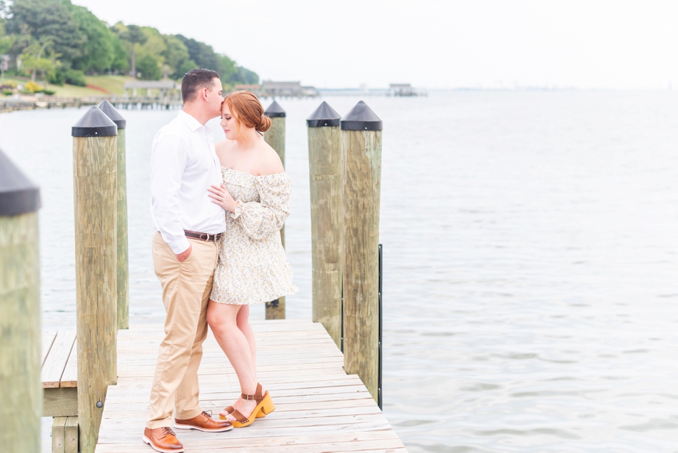 groom kisses forehead of bride during engagement session with wedding photographer in Virginia