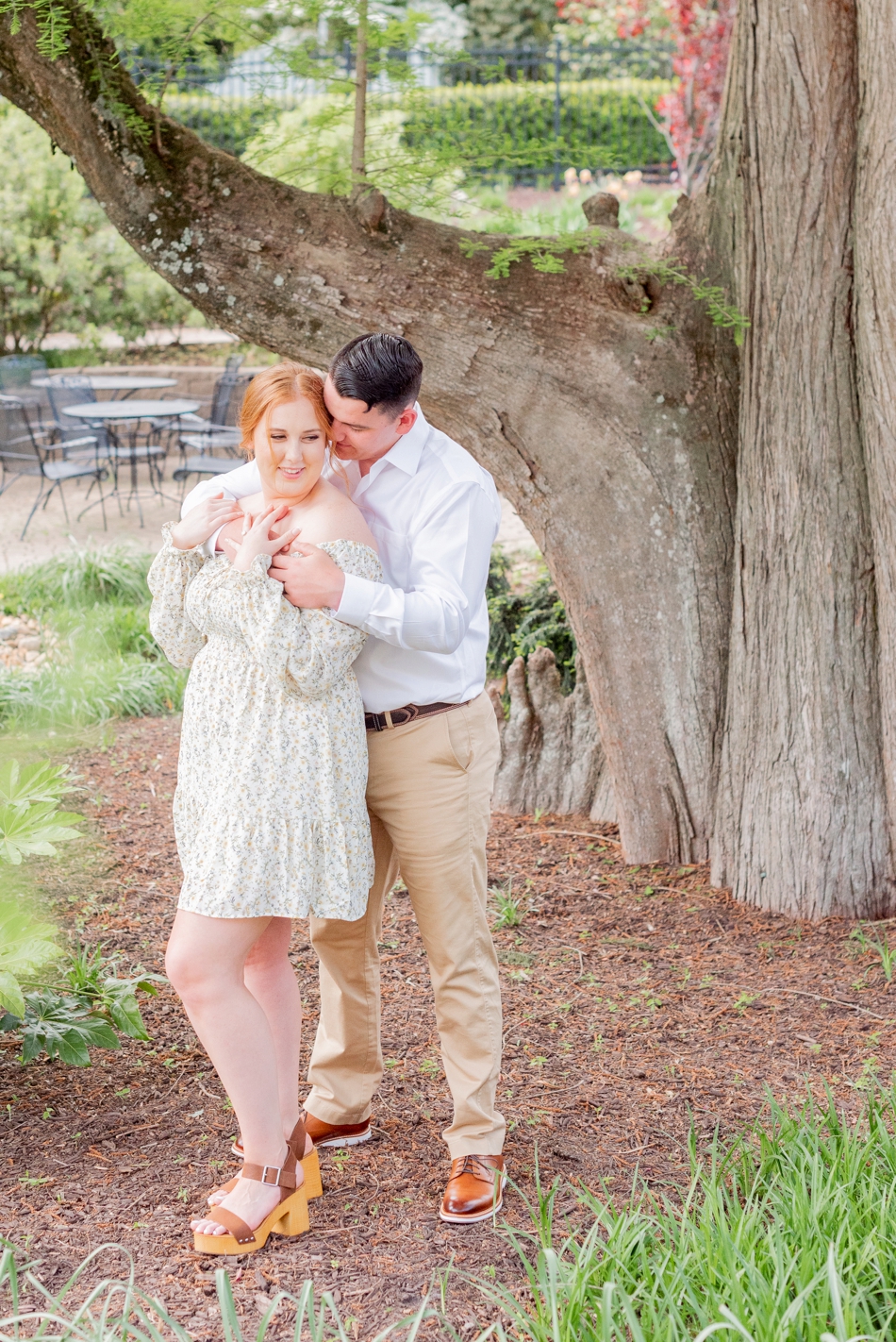 Engaged couple have arms around each other during engagement photos at James River Country Club in Virginia